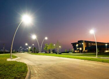 road next to Central Park building at night with street lights